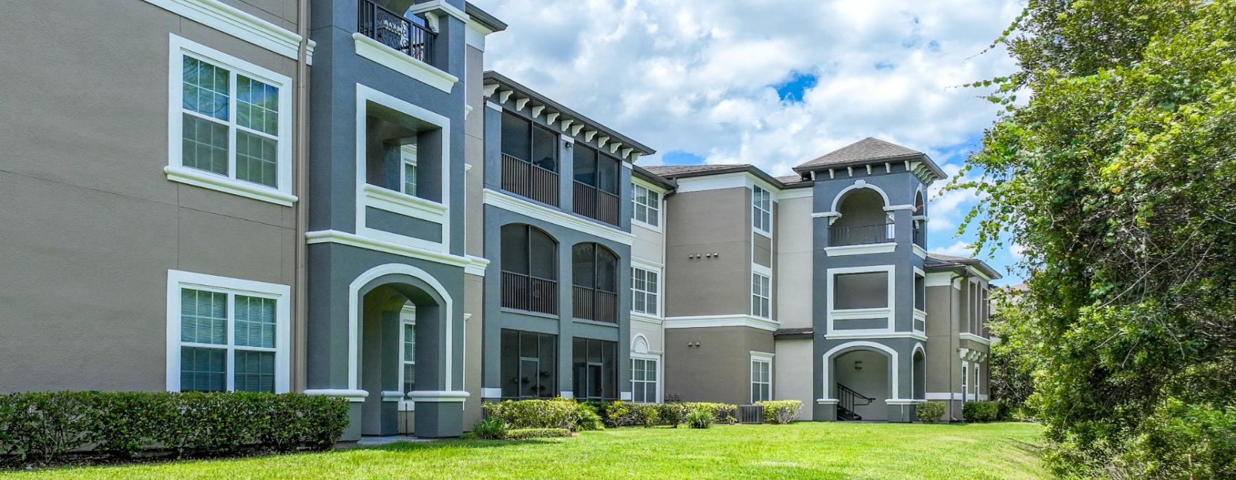 a large building with a lawn in front of it