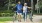 a man and woman walking with a bicycle