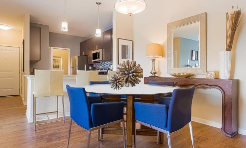 a dining room with a table and chairs