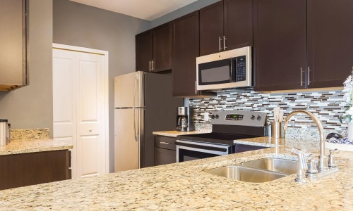 a kitchen with black cabinets