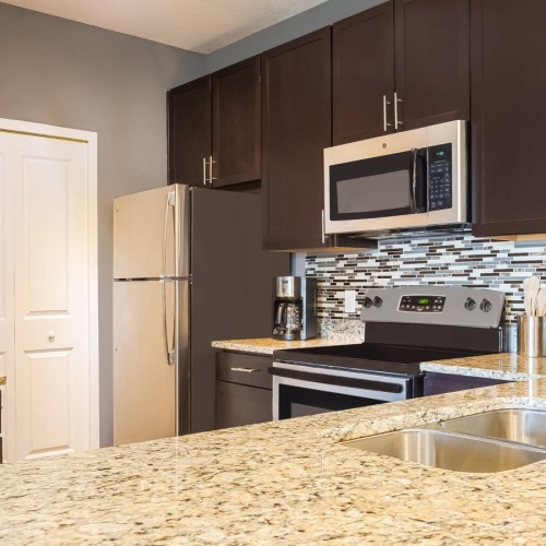 a kitchen with black cabinets